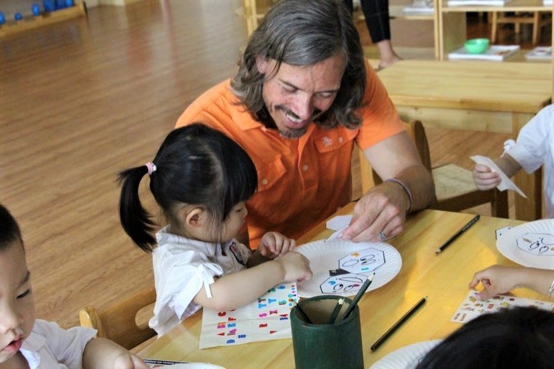Child and teacher working together on an art project